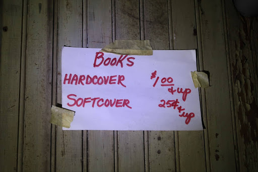Sign saying "Books" with listed prices.