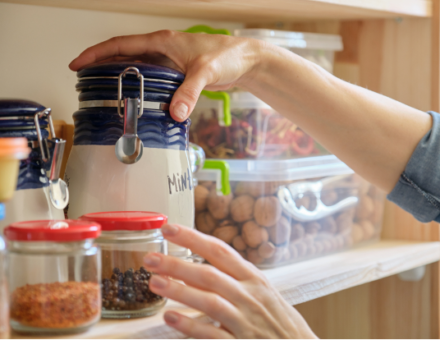 Person grabbing items out of pantry