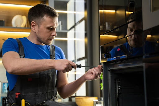 Man working on appliances.