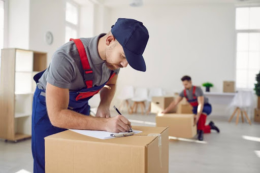 Man writing on boxes.