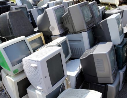 computers stacked and ready to be recycled