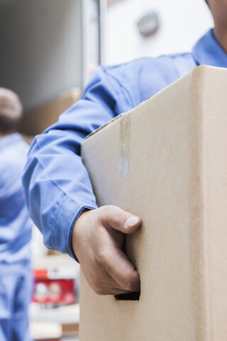 men loading boxes out of a moving truck