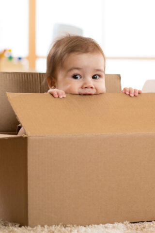 baby chewing on box