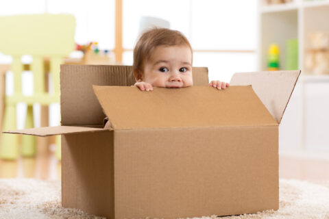 baby chewing on box