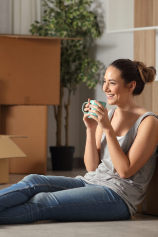 Person smiling next to boxes