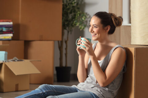 Person smiling next to boxes