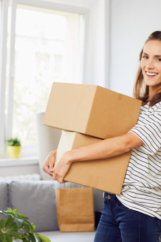 A woman carrying boxes.