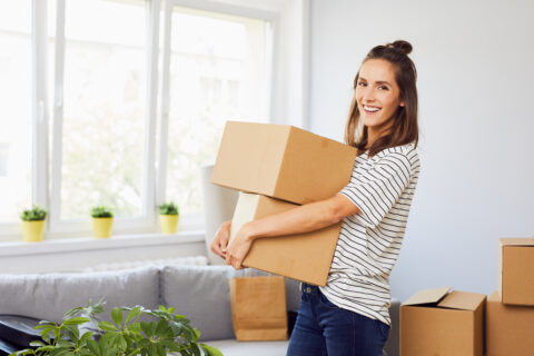 A woman carrying boxes.