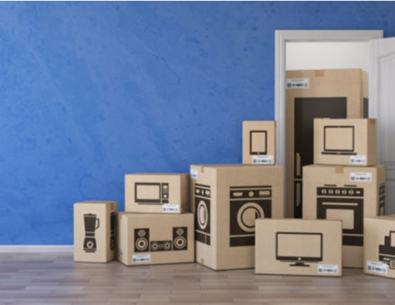 Cardboard boxes with images of electronics labeled on the outside