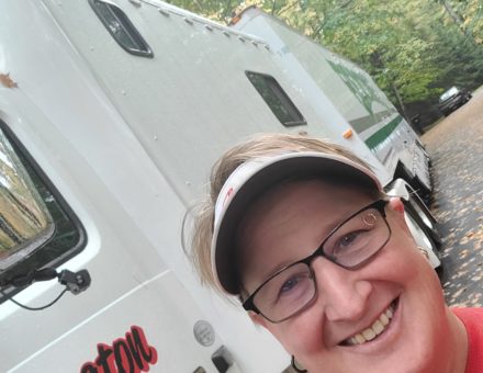 woman taking a selfie in front of a Wheaton's moving truck
