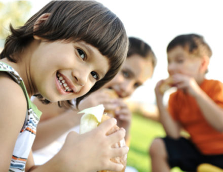 group of kids eating outdoors