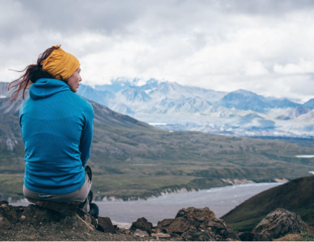 Woman sitting on a mountain
