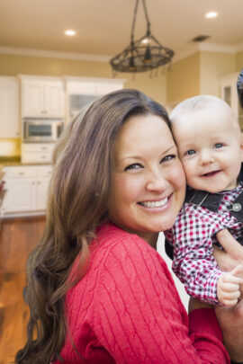 family of three smiling in kitchen