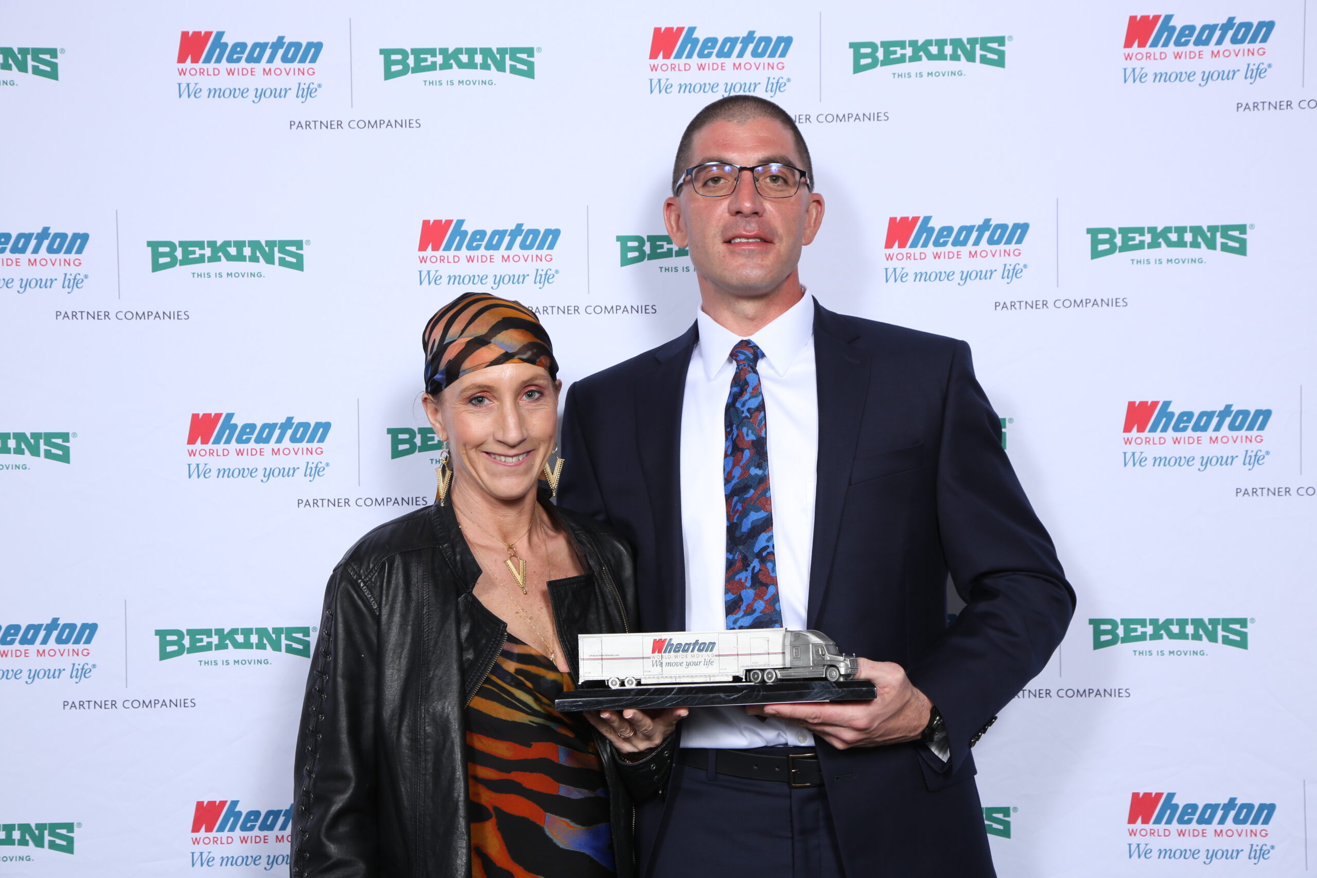 Wheaton driver and wife pose with driver of the year trophy. 