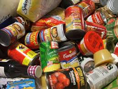 Food cans and tins on the shelf of a store cupboard Stock Photo