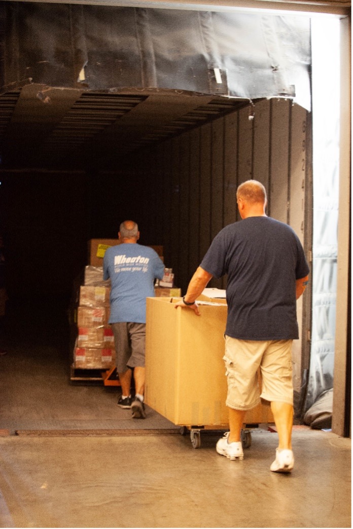 wheaton volunteers moving brown boxes