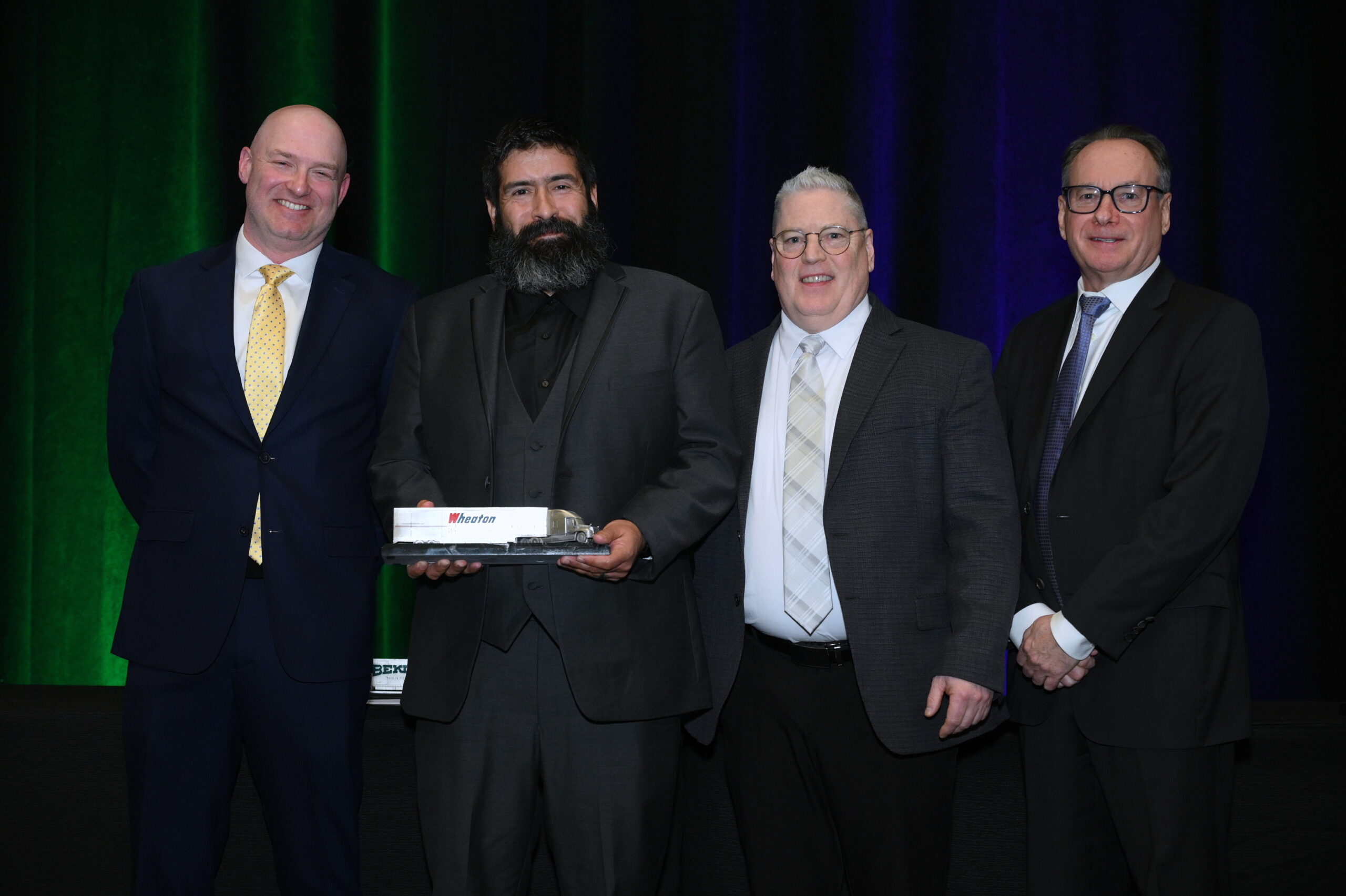 Marc Bailey, 2022 Wheaton Driver of the Year, with Wheaton leadership at the network Awards Gala in March