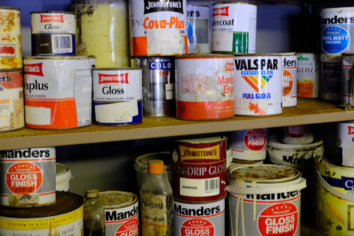 Shelves with jars of hazardous materials like gloss finish. 