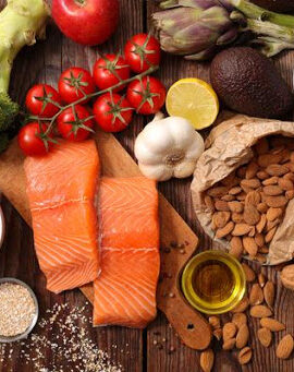 overhead shot of various healthy foods arranged on a wooden table