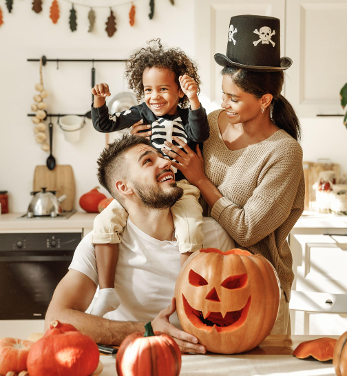 Happy family carving pumpkins