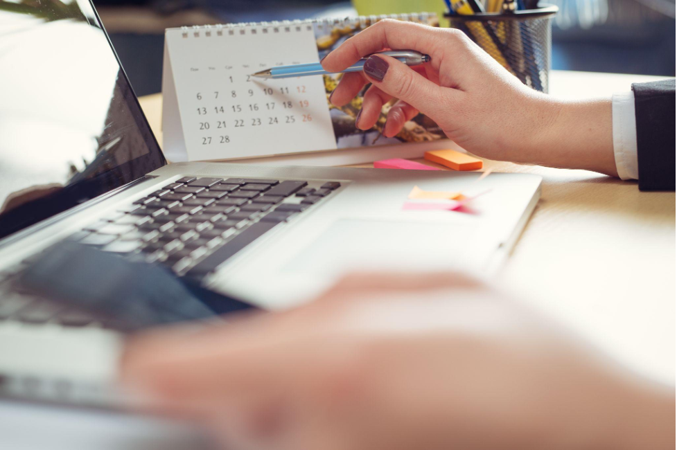 Woman checking her calendar at work
