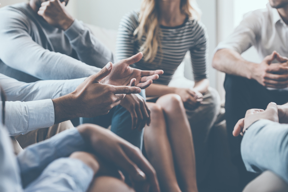 Friends spending time together sitting in a circle