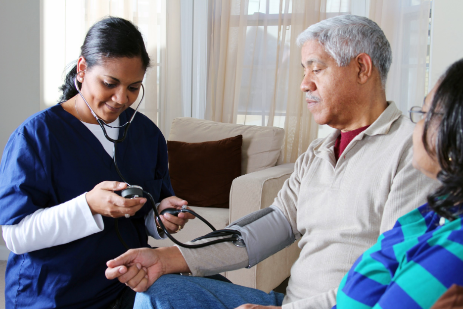 Man getting blood pressure taken by nurse