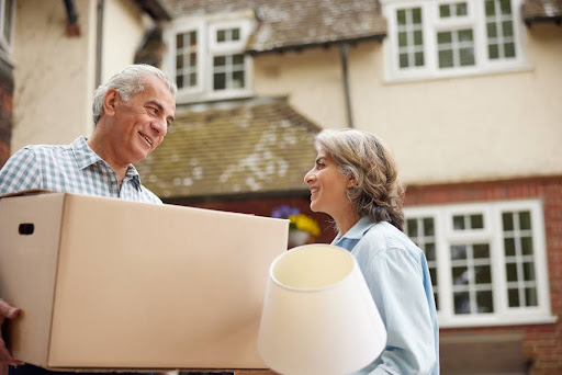 Two older adults smiling at each other.