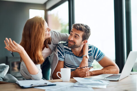 A man and woman review their moving checklist.