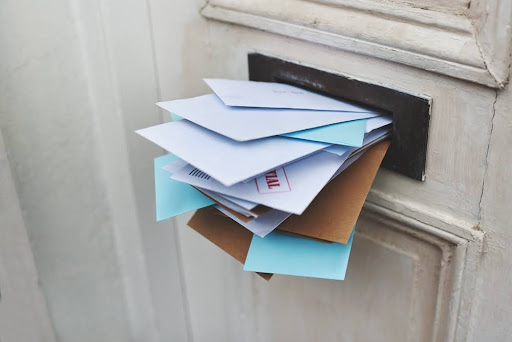 Mail sticking out of a mail slot.