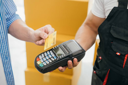 Person swiping a credit card.