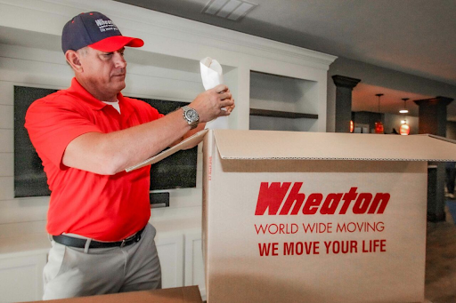 Man wrapping delicate items.